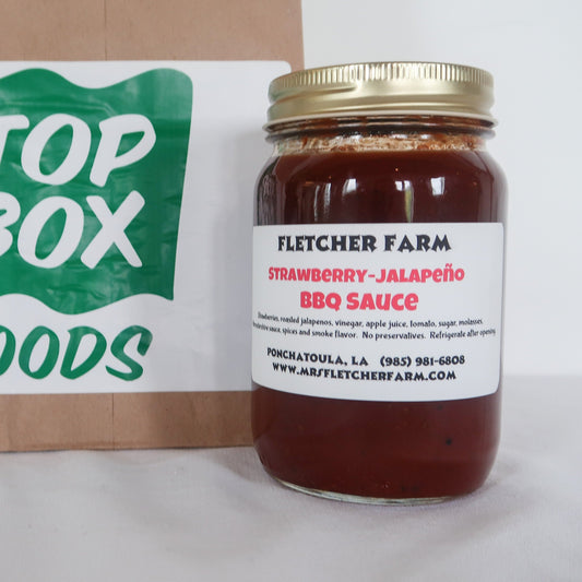 8oz jar of local Mrs. Fletcher Farms Strawberry Jalape√±o BBQ Sauce from Fletcher Farms. This spicy-sweet BBQ sauce is made with local Ponchatoula strawberries and fresh jalape√±os.